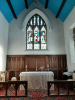 The Main Alter of Holy Trinity Church with the stained glass window showing Mary & Martha serving the Lord